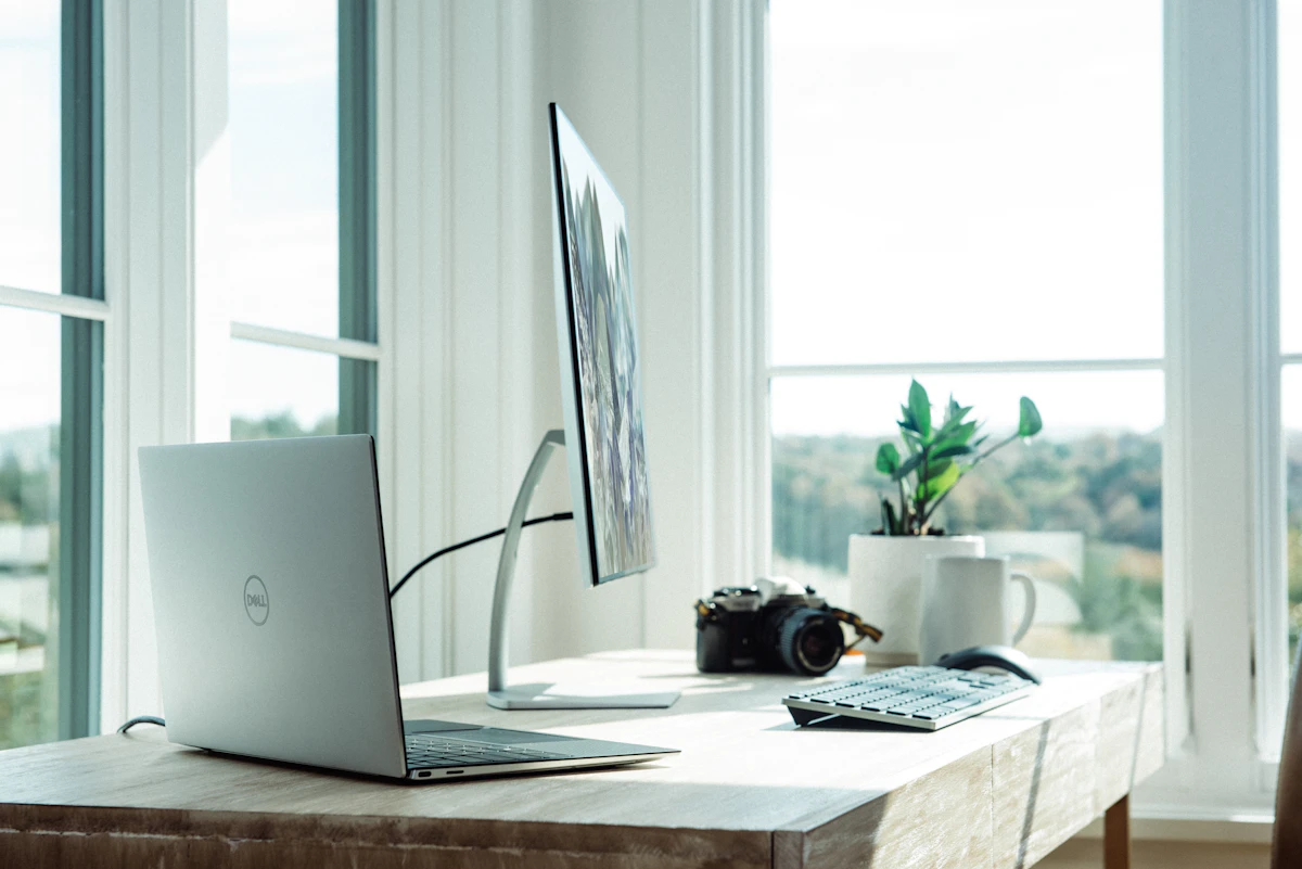Tidy home office desk with monitor, lamp and ergonomic chair